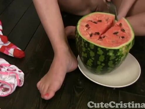 Charming Christina squashing watermelon