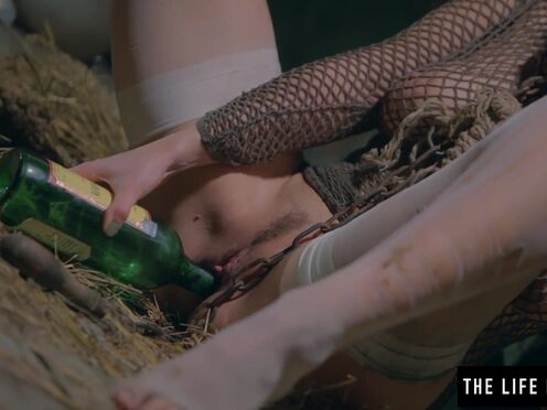 Babe is chained in a dirty basement masturbating with a bottle