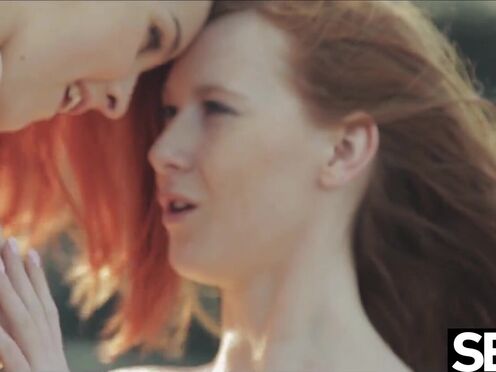 Watch these two hot redheads have wild lesbian sex on the beach
