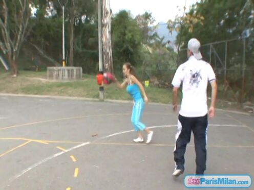 Paris Milan plays basketball outdoors