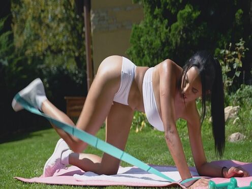 Trainer helps Katrina Moreno with her hot out door training