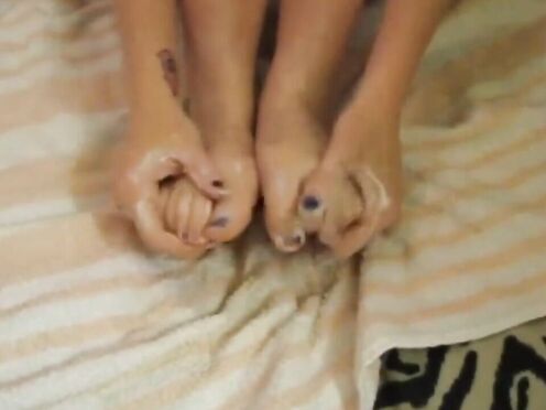Hot brunette moisturising her pretty feet