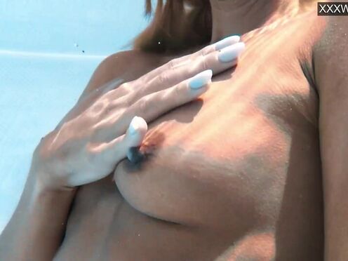 Captivating Candee Licious swimming naked