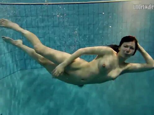 Sexy beauty swims in the sea like a mermaid