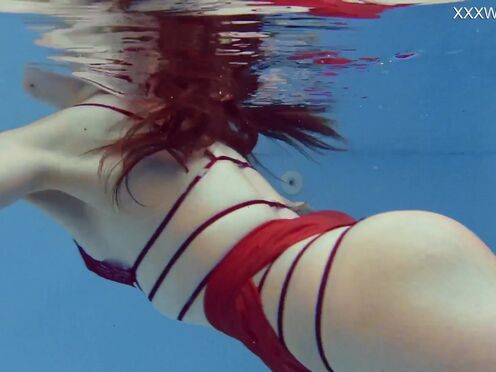Very small teen in red swimming & posing