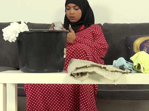 Bushy female in hijab doing extra cleaning