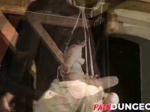 Gagged brunette is spanked by master in dungeon play