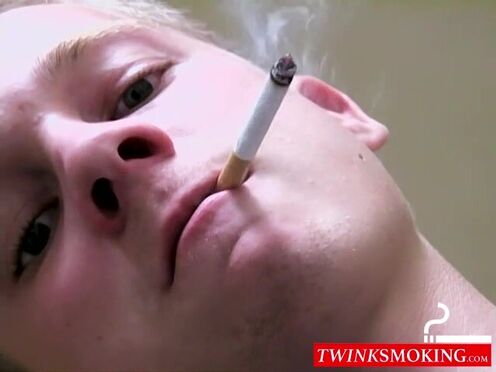 Twink savors the pleasure of smoking & stroking dick